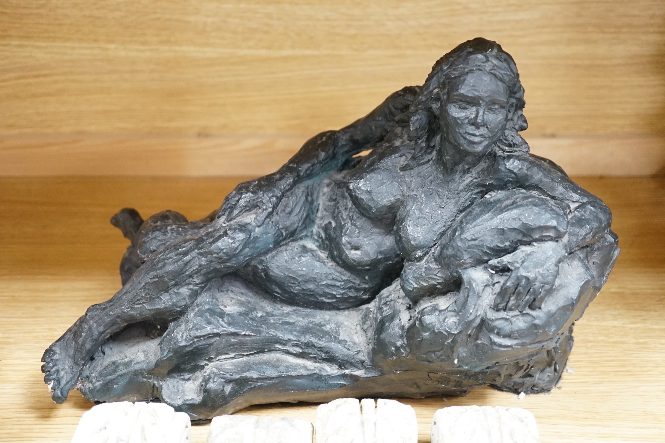 A plaster figural reclining nude signed ‘Roch’ and eight stone mounts